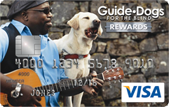 Graduate playing guitar while guide dog "sings"